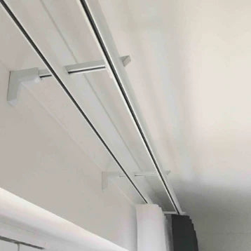 Close-up of a modern ceiling light fixture with metallic finish.